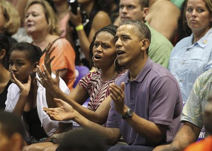 U.S President Barack Obama and first lady Michelle react as they watch the Diamond Head basketball game between Oregon State and Akron durin U.S President Barack Obama and first lady Michelle react as they watch the Diamond Head basketball game between Oregon State and Akron durin