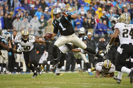 Dec 22, 2013; Charlotte, NC, USA; Carolina Panthers quarterback Cam Newton (1) runs as New Orleans Saints middle linebacker Curtis Lofton (5 Dec 22, 2013; Charlotte, NC, USA; Carolina Panthers quarterback Cam Newton (1) runs as New Orleans Saints middle linebacker Curtis Lofton (5