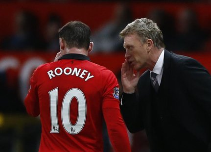 Manchester United's manager David Moyes (R) speaks to Wayne Rooney during their English Premier League soccer match against West Ham at Old Manchester United's manager David Moyes (R) speaks to Wayne Rooney during their English Premier League soccer match against West Ham at Old