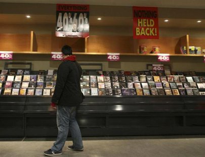 A customer looks through racks for CD's during a sale at a store in New York's Times Square March 13, 2009. REUTERS/Brendan McDermid A customer looks through racks for CD's during a sale at a store in New York's Times Square March 13, 2009. REUTERS/Brendan McDermid
