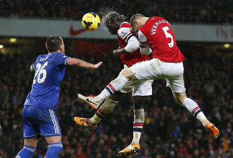 Arsenal's Bacary Sagna (C) and Thomas Vermaelen (R) jump to head the ball as Chelsea's John Terry looks on during their English Premier Leag Arsenal's Bacary Sagna (C) and Thomas Vermaelen (R) jump to head the ball as Chelsea's John Terry looks on during their English Premier Leag
