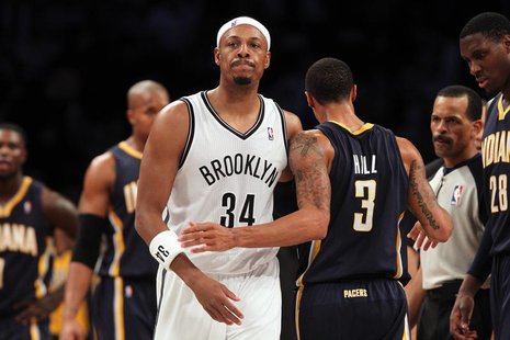Brooklyn Nets small forward Paul Pierce (34) and Indiana Pacers point guard George Hill (3) walk past one another after Pierce was called fo Brooklyn Nets small forward Paul Pierce (34) and Indiana Pacers point guard George Hill (3) walk past one another after Pierce was called fo