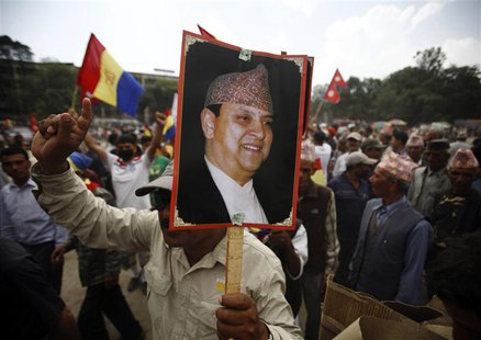 A supporter of the Rastriya Prajatantra Party Nepal (RPP-Nepal) holds a portrait of former King Gyanendra Shah during a protest rally in Kat A supporter of the Rastriya Prajatantra Party Nepal (RPP-Nepal) holds a portrait of former King Gyanendra Shah during a protest rally in Kat
