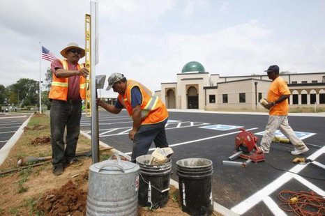 People put up handicap parking signs at a car park, August 10, 2012.
CREDIT: REUTERS/HARRISON MCCLARY People put up handicap parking signs at a car park, August 10, 2012.
CREDIT: REUTERS/HARRISON MCCLARY