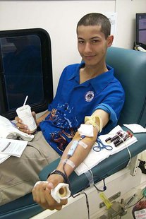 A young person donating blood. A young person donating blood.