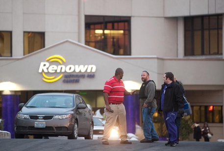 A Reno Police officer (2nd L) talks with employees of the Renown Regional Medical Center following a lockdown in Reno, Nevada December 17, 2 A Reno Police officer (2nd L) talks with employees of the Renown Regional Medical Center following a lockdown in Reno, Nevada December 17, 2