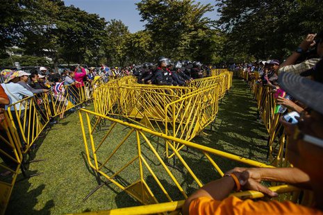 Riot police officers are surrounded by barricades after being detained by anti-government protesters during a rally at The Thai-Japan youth Riot police officers are surrounded by barricades after being detained by anti-government protesters during a rally at The Thai-Japan youth