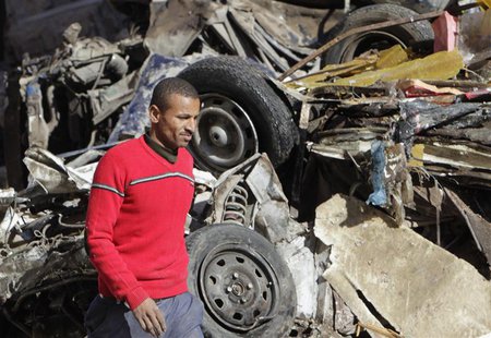 A man walks near a damaged vehicle after an explosion near a security building in Egypt's Nile Delta city of Mansoura in Dakahlyia province, A man walks near a damaged vehicle after an explosion near a security building in Egypt's Nile Delta city of Mansoura in Dakahlyia province,