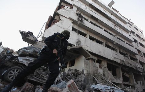 A riot policeman stands outside the building of the Directorate of Security after an explosion in Egypt's Nile Delta town of Dakahlyia, abou A riot policeman stands outside the building of the Directorate of Security after an explosion in Egypt's Nile Delta town of Dakahlyia, abou