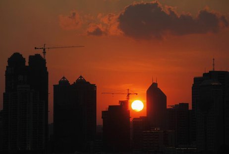 The sun sets behind buildings under construction in Guangzhou, Guangdong province July 4, 2010. REUTERS/Joe Tan The sun sets behind buildings under construction in Guangzhou, Guangdong province July 4, 2010. REUTERS/Joe Tan