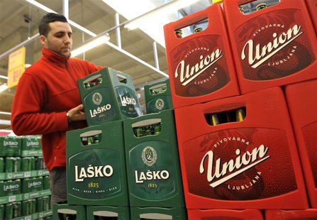 A worker stacks cases of Lasko and Union beer at Mercator shopping mall in Ljubljana December 20, 2013. REUTERS/Srdjan Zivulovic A worker stacks cases of Lasko and Union beer at Mercator shopping mall in Ljubljana December 20, 2013. REUTERS/Srdjan Zivulovic