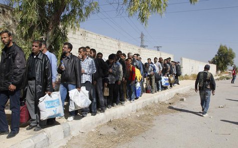Syrian men wait to leave the besieged town of al-Mouadamiya, which is controlled by opposition fighters, in Damascus countryside October 29, Syrian men wait to leave the besieged town of al-Mouadamiya, which is controlled by opposition fighters, in Damascus countryside October 29,