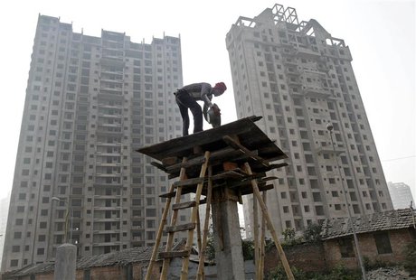 A labourer works at the construction site of a residential complex in Kolkata December 21, 2013. India's biggest cities face a worsening sho A labourer works at the construction site of a residential complex in Kolkata December 21, 2013. India's biggest cities face a worsening sho