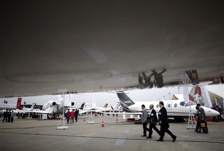 Guests walk next to aircrafts as they attend the Shanghai International Business Aviation Show at the Hongqiao International Airport in Shan Guests walk next to aircrafts as they attend the Shanghai International Business Aviation Show at the Hongqiao International Airport in Shan