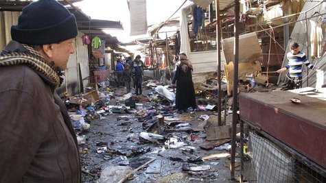 A man looks at the site of bomb attack at a marketplace in Baghdad's Doura District December 25 2013. REUTERS/Ahmed Malik A man looks at the site of bomb attack at a marketplace in Baghdad's Doura District December 25 2013. REUTERS/Ahmed Malik