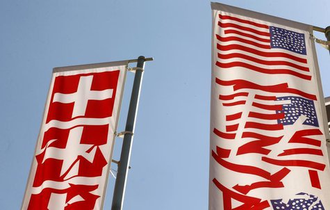 Stylized Swiss and U.S. (R) national flags fly on a roundabout in the town of Obersiggenthal near Zurich May 28, 2013. REUTERS/Arnd Wiegmann Stylized Swiss and U.S. (R) national flags fly on a roundabout in the town of Obersiggenthal near Zurich May 28, 2013. REUTERS/Arnd Wiegmann