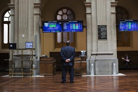 A trader looks at electronic boards at Madrid's stock exchange June 29, 2012. REUTERS/Susana Vera A trader looks at electronic boards at Madrid's stock exchange June 29, 2012. REUTERS/Susana Vera