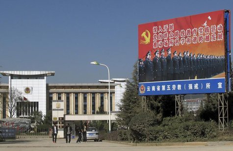 People walk outside a labour camp in Kunming, Yunnan province, November 22, 2013. REUTERS/John Ruwitch People walk outside a labour camp in Kunming, Yunnan province, November 22, 2013. REUTERS/John Ruwitch