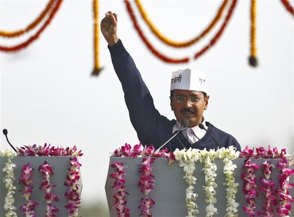 Arvind Kejriwal, leader of Aam Aadmi (Common Man) Party (AAP), shouts slogans after taking the oath as the new chief minister of Delhi durin Arvind Kejriwal, leader of Aam Aadmi (Common Man) Party (AAP), shouts slogans after taking the oath as the new chief minister of Delhi durin