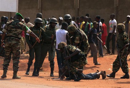 Personnel from the African Union peacekeeping mission to Central African Republic (MISCA) control a fighting crowd near the airport, in the Personnel from the African Union peacekeeping mission to Central African Republic (MISCA) control a fighting crowd near the airport, in the