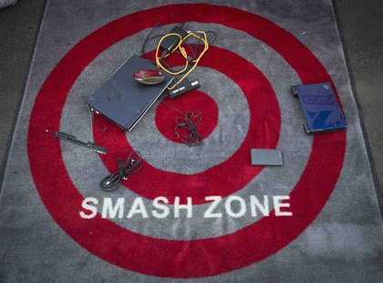 Computers and outdated electronic gadgets that have been smashed sit on a carpet during "Good Riddance Day" in Times Square in New York, Dec Computers and outdated electronic gadgets that have been smashed sit on a carpet during "Good Riddance Day" in Times Square in New York, Dec