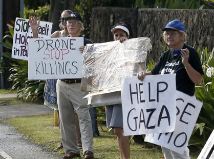 Protesters hold signs as the motorcade of U.S. President Barack Obama returns to Obama's vacation home in Kailua, Hawaii December 28, 2013. Protesters hold signs as the motorcade of U.S. President Barack Obama returns to Obama's vacation home in Kailua, Hawaii December 28, 2013.