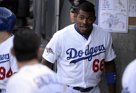 October 16, 2013; Los Angeles, CA, USA; Los Angeles Dodgers right fielder Yasiel Puig (66) reacts after first baseman Adrian Gonzalez (23) h October 16, 2013; Los Angeles, CA, USA; Los Angeles Dodgers right fielder Yasiel Puig (66) reacts after first baseman Adrian Gonzalez (23) h