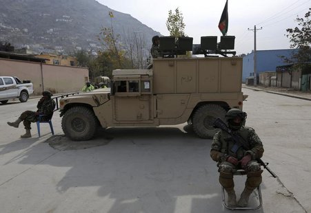 Afghan National Army (ANA) soldiers keep watch near a building in which the Loya Jirga (or grand council) is holding a committee session, in Afghan National Army (ANA) soldiers keep watch near a building in which the Loya Jirga (or grand council) is holding a committee session, in