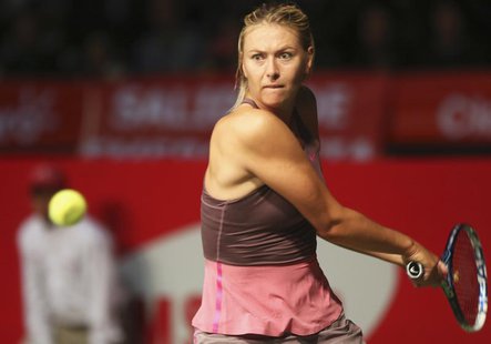 Russia's Maria Sharapova returns a shot to Serbia's Ana Ivanovic during their exhibition match in Bogota December 6, 2013. REUTERS/John Vizc Russia's Maria Sharapova returns a shot to Serbia's Ana Ivanovic during their exhibition match in Bogota December 6, 2013. REUTERS/John Vizc