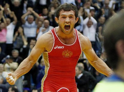 Besik Kudukhov of Russia celebrates his victory over Vasyl Fedoryshyn of Ukraine in their 60kg men's freestyle gold medal match at the World Besik Kudukhov of Russia celebrates his victory over Vasyl Fedoryshyn of Ukraine in their 60kg men's freestyle gold medal match at the World