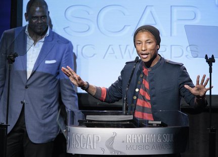 Producer, songwriter and rapper Pharrell Williams (R) accepts the Golden Note Award as Jon Platt, president of EMI Music Publishing, looks o Producer, songwriter and rapper Pharrell Williams (R) accepts the Golden Note Award as Jon Platt, president of EMI Music Publishing, looks o