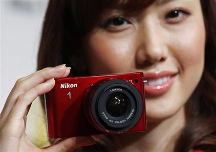 A model poses with Nikon Corp's new Nikon 1 J1 camera at its unveiling ceremony in Tokyo, in this September 21, 2011 file photo. REUTERS/Kim A model poses with Nikon Corp's new Nikon 1 J1 camera at its unveiling ceremony in Tokyo, in this September 21, 2011 file photo. REUTERS/Kim