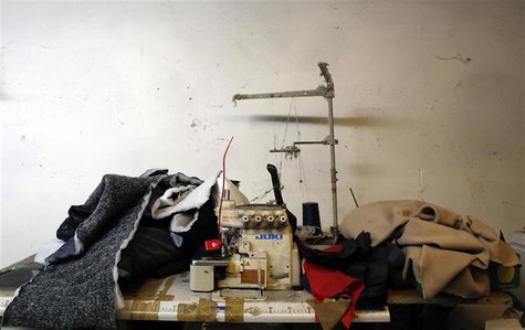An industrial sewing machine is pictured as police officers conduct a check at the Shen Wu textile factory in Prato December 9, 2013. REUTER An industrial sewing machine is pictured as police officers conduct a check at the Shen Wu textile factory in Prato December 9, 2013. REUTER