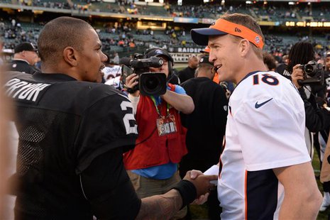 December 29, 2013; Oakland, CA, USA; Denver Broncos quarterback Peyton Manning (18) shakes hands with Oakland Raiders quarterback Terrelle P December 29, 2013; Oakland, CA, USA; Denver Broncos quarterback Peyton Manning (18) shakes hands with Oakland Raiders quarterback Terrelle P