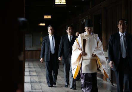 Japan's Prime Minister Shinzo Abe (2nd L) is led by a Shinto priest as he visits Yasukuni shrine in Tokyo December 26, 2013. REUTERS/Toru Ha Japan's Prime Minister Shinzo Abe (2nd L) is led by a Shinto priest as he visits Yasukuni shrine in Tokyo December 26, 2013. REUTERS/Toru Ha