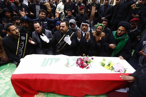Mourners pray near the coffin of a soldier, who was killed during the clashes in Ramadi during the funeral in Najaf, 160 km (99 miles) south Mourners pray near the coffin of a soldier, who was killed during the clashes in Ramadi during the funeral in Najaf, 160 km (99 miles) south