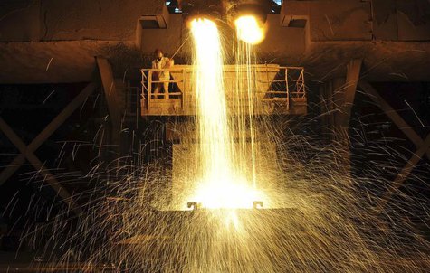 A labourer guides as slag is poured into a container at Dongbei Special Steel Group Co. Ltd. in Dalian, Liaoning province December 27, 2013. A labourer guides as slag is poured into a container at Dongbei Special Steel Group Co. Ltd. in Dalian, Liaoning province December 27, 2013.