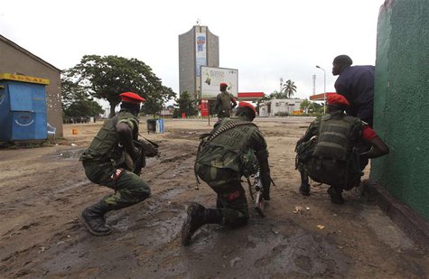 Congolese security officers position themselves as they secure the street near the state television headquarters (C) in the capital Kinshasa Congolese security officers position themselves as they secure the street near the state television headquarters (C) in the capital Kinshasa