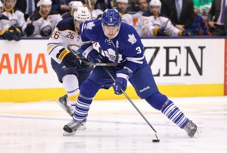 Dec 27, 2013; Toronto, Ontario, CAN; Toronto Maple Leafs defenseman Dion Phaneuf (3) goes to the net with the puck as he is checked by Buffa Dec 27, 2013; Toronto, Ontario, CAN; Toronto Maple Leafs defenseman Dion Phaneuf (3) goes to the net with the puck as he is checked by Buffa