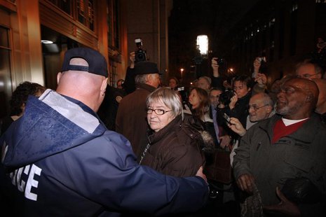 A police officer puts his arm around disbarred lawyer Lynne Stewart (C) as she arrives at federal court to begin her prison sentence after b A police officer puts his arm around disbarred lawyer Lynne Stewart (C) as she arrives at federal court to begin her prison sentence after b