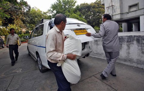 Central Bureau of Investigation (CBI) officials carry a bag of documents after conducting a raid at a building as part of probes into the Ag Central Bureau of Investigation (CBI) officials carry a bag of documents after conducting a raid at a building as part of probes into the Ag