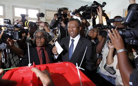 Madagascar's presidential candidate Hery Rajaonarimampianina (C) holds his ballot before casting his vote at a polling centre in Tsimbazaza Madagascar's presidential candidate Hery Rajaonarimampianina (C) holds his ballot before casting his vote at a polling centre in Tsimbazaza