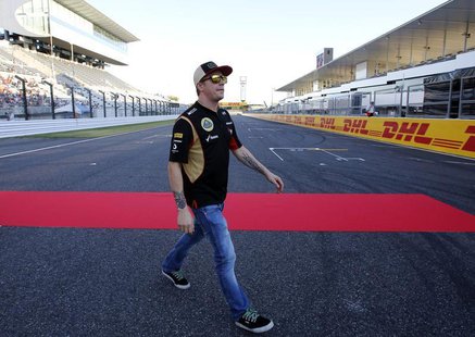 Lotus F1 Formula One driver Kimi Raikkonen of Finland walks on the track at the Suzuka circuit October 10, 2013, ahead of Sunday's Japanese Lotus F1 Formula One driver Kimi Raikkonen of Finland walks on the track at the Suzuka circuit October 10, 2013, ahead of Sunday's Japanese
