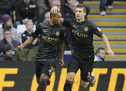 Manchester City's Fernandinho (L) celebrates scoring a goal against Swansea City with Matija Nastasic during their English Premier League so Manchester City's Fernandinho (L) celebrates scoring a goal against Swansea City with Matija Nastasic during their English Premier League so