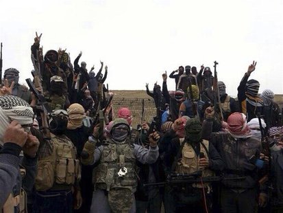 Gunmen gesture during fighting in Ramadi January 1, 2014. REUTERS/Stringer Gunmen gesture during fighting in Ramadi January 1, 2014. REUTERS/Stringer