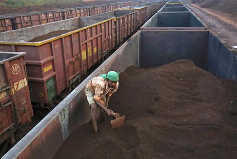 A worker levels the iron ore in a freight train at a railway station at Chitradurga in the southern Indian state of Karnataka in this Novemb A worker levels the iron ore in a freight train at a railway station at Chitradurga in the southern Indian state of Karnataka in this Novemb