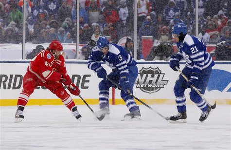 Detroit Red Wings left wing Henrik Zetterberg (40) battles for the puck with Toronto Maple Leafs defenseman Dion Phaneuf (3) and left wing J Detroit Red Wings left wing Henrik Zetterberg (40) battles for the puck with Toronto Maple Leafs defenseman Dion Phaneuf (3) and left wing J