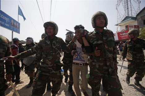 Cambodian soldiers escort a worker who had been taking part in a protest after clashes broke out, on the outskirts of Phnom Penh January 2, Cambodian soldiers escort a worker who had been taking part in a protest after clashes broke out, on the outskirts of Phnom Penh January 2,