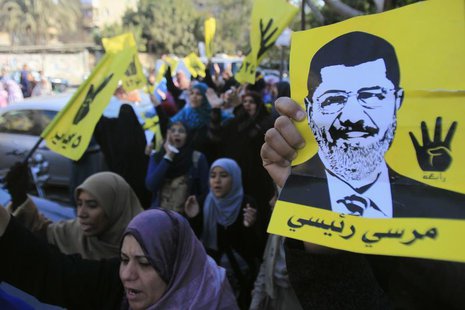 Supporters of the Muslim Brotherhood and ousted Egyptian President Mohamed Mursi shout slogans against the military and interior ministry wh Supporters of the Muslim Brotherhood and ousted Egyptian President Mohamed Mursi shout slogans against the military and interior ministry wh
