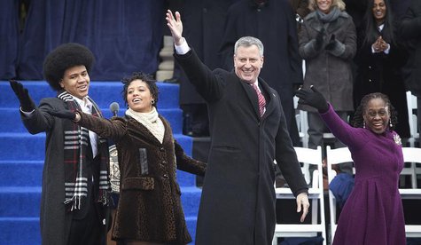 New mayor Bill de Blasio (2nd R) and his wife Chirlane de Blasio (R) blow a kiss to the crowd with their son Dante de Blasio (L) and daughte New mayor Bill de Blasio (2nd R) and his wife Chirlane de Blasio (R) blow a kiss to the crowd with their son Dante de Blasio (L) and daughte